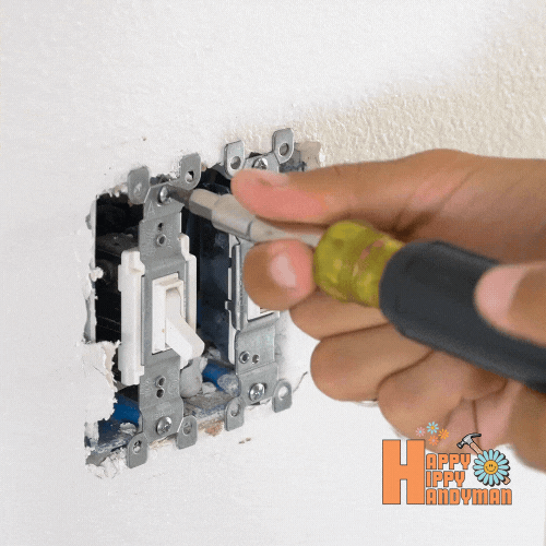 Close-up of a lighting switch being screwed into place during an electrical installation