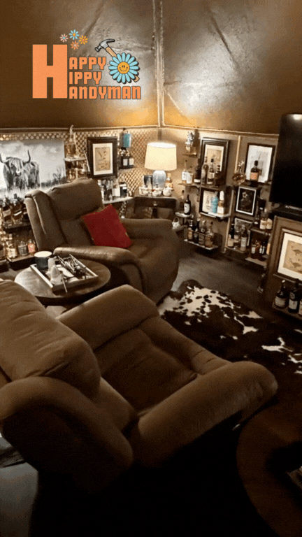A cozy man cave in Barrington outfitted with a mounted television, a comfy chair, and an old hide rug, blending comfort with stylish interior design