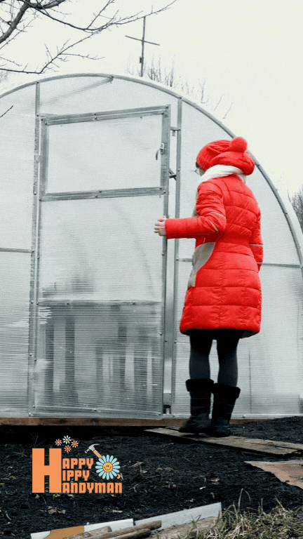 Woman in a vibrant red coat stepping into a polycarbonate greenhouse on a cold winter day, highlighting the efficiency of our Greenhouse Builds & Installation Services in even the harshest climates.